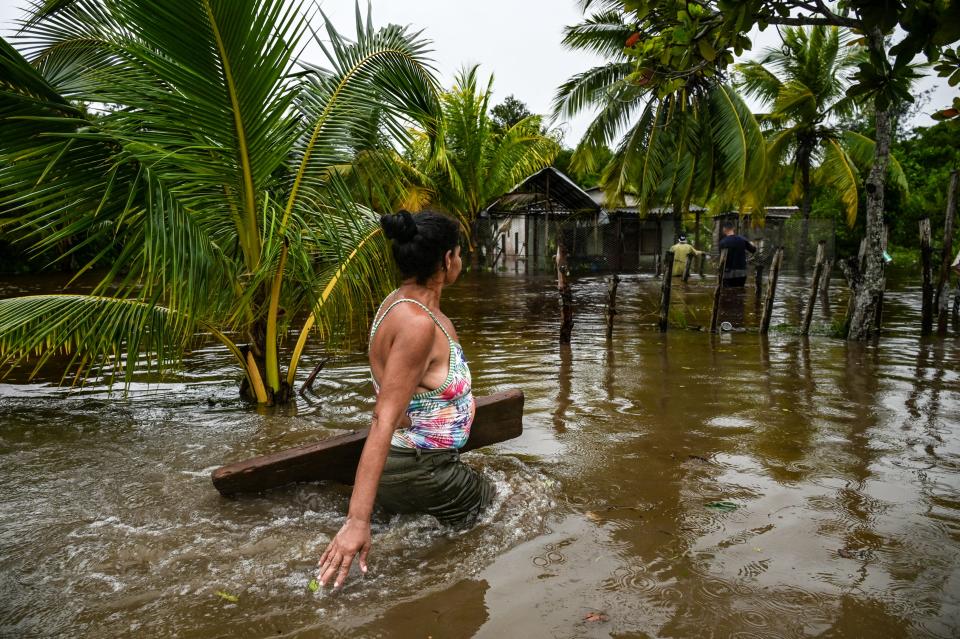 A woman trudges through a flooded street after the passage of Hurricane Helene in Guanimar, Cuba (AFP via Getty Images)