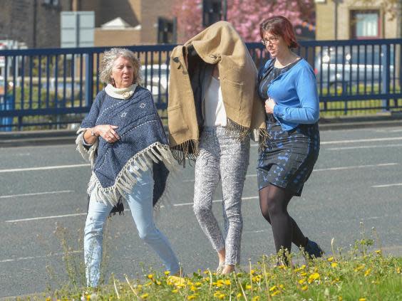 Sarah Higgins, 42, pictured centre leaving Huddersfield Magistrates' Court in April 2019, has been charged with manslaughter over the death of 10-month-old Skylar Giller in August 2017. (Alex Cousins/SWNS/file photo)