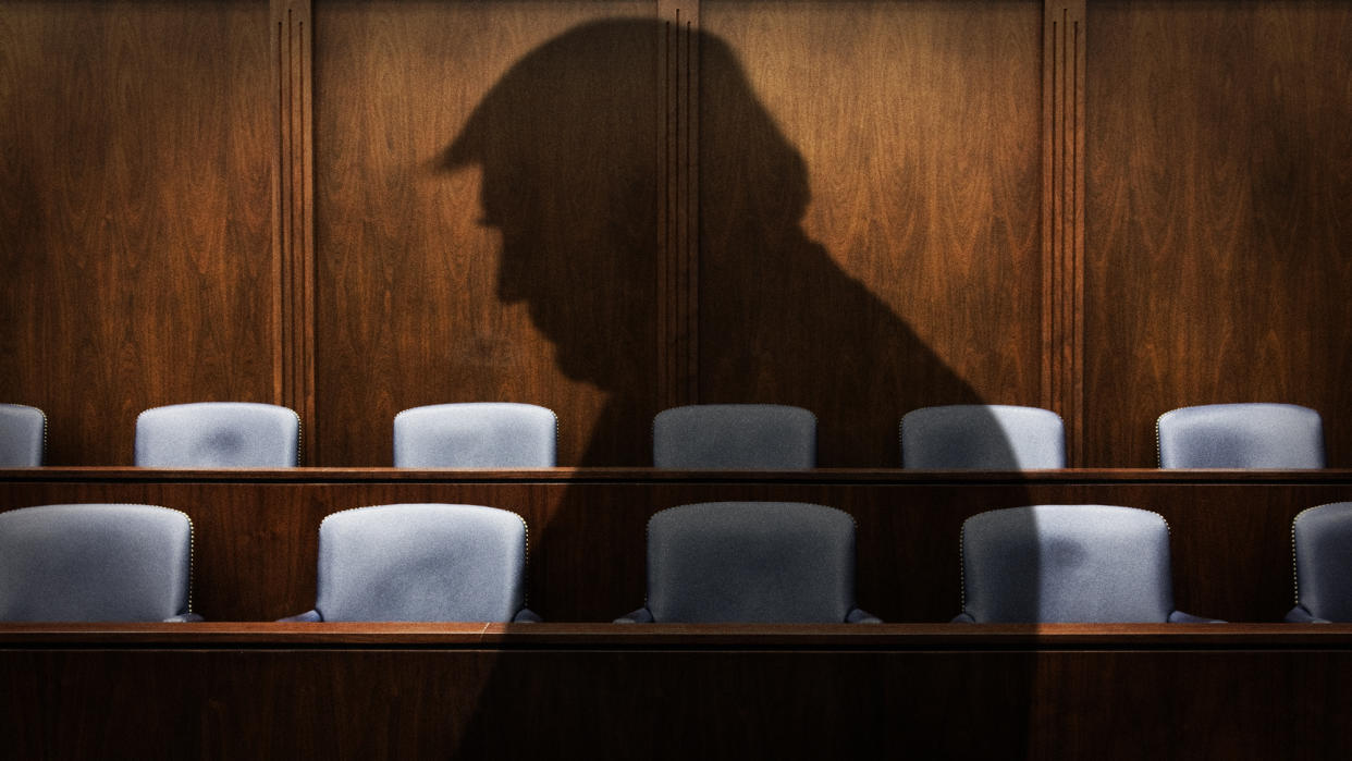  Silhouette of Donald Trump against a jury box. 