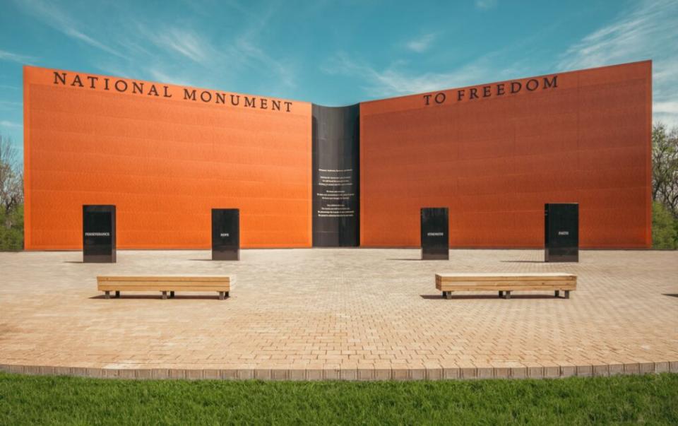 A large orange wall saying "National Monument to Freedom"