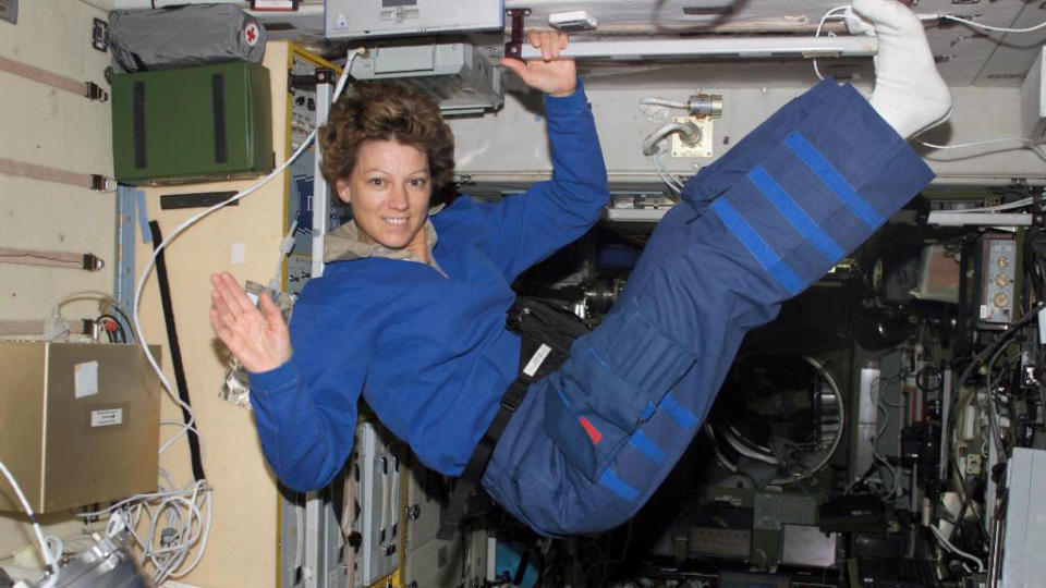 Eileen Collins smiling at the camera while 'floating' in microgravity conditions.