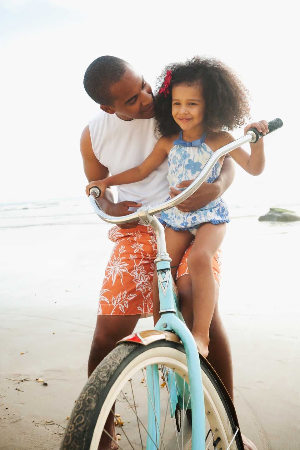 summer activities dad teaching daughter how to ride a bike