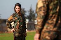 A Kurdish woman fighter of the US-backed Syrian Democratic Forces attends the funeral on December 21, 2018, of an Arab comrade killed in the campaign against the Islamic State group's last Syria enclave, among hundreds killed since September