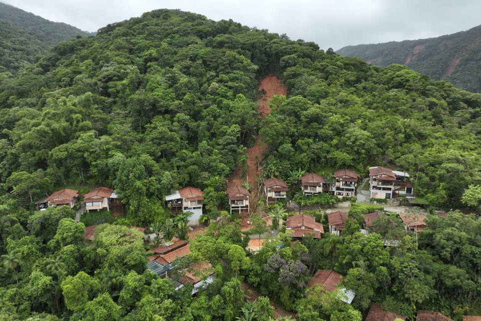 A hillside is exposed after flooding triggered deadly landslides near Juquehy beach in Sao Sebastiao, Brazil, Monday, Feb. 20, 2023. (AP Photo/Andre Penner)