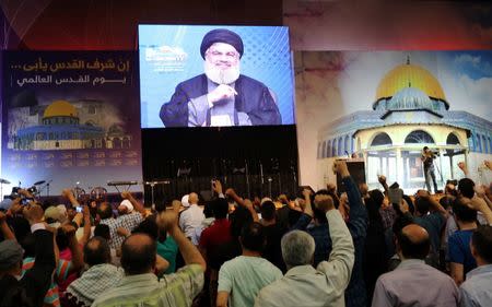 Lebanon's Hezbollah leader Sayyed Hassan Nasrallah addresses his supporters via a screen during a rally marking Al-Quds day in Beirut's southern suburbs, Lebanon June 23, 2017. RREUTERS/Aziz Taher