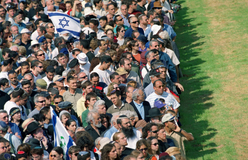 FILE - In this Oct. 18 2001 file photo, mourners wait to pass by the flag-draped coffin of assassinated Israeli Tourism Minister Rehavam Zeevi, who lies in state in front of the Knesset, Israel's parliament, in Jerusalem. Israel and the Palestinians have a history of assassinations. Israel’s Mossad killed several top PLO and Hamas leaders in the Arab world and Gaza. A Palestinian splinter group attempted and failed to kill the Israeli ambassador to the United Kingdom in 1982 and Palestinian militants assassinated Israel’s tourism minister in 2001. (AP Photo/Lefteris Pitarakis, File)