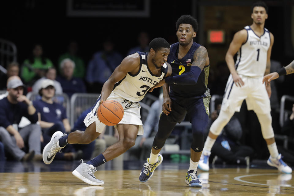 Butler's Kamar Baldwin (3) is defended by Marquette's Sacar Anim (2) during overtime of an NCAA college basketball game, Friday, Jan. 24, 2020, in Indianapolis. Butler won 89-85. (AP Photo/Darron Cummings)