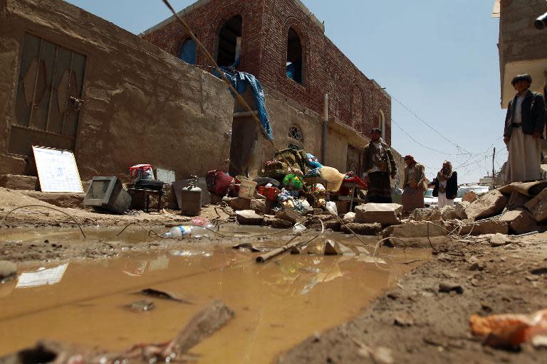 Yemenis gather near the rubble of houses near Sanaa Airport on March 31, 2015