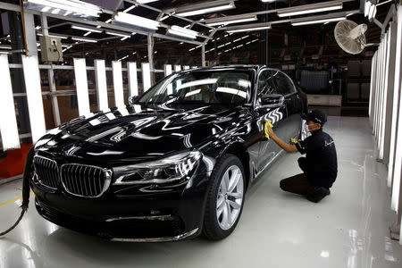 A worker checks the paint on a locally assembled new BMW 7 Series at a Gaya Motor assembly plant in Jakarta, Indonesia November 30, 2016. REUTERS/Darren Whiteside