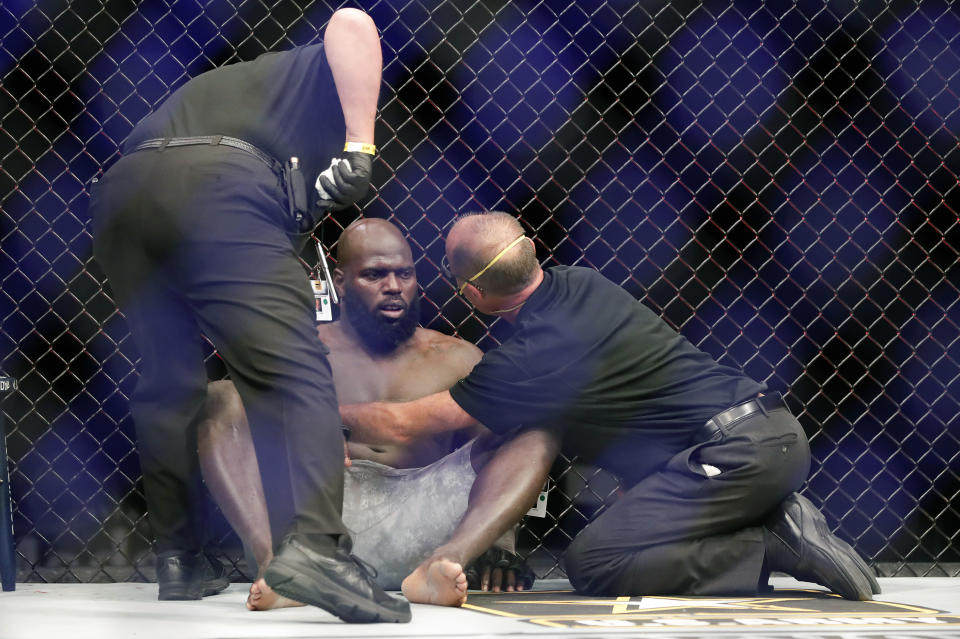 CORRECTS TO JAIRZINHO ROZENSTRUIK NOT JAIRZINHO ROZENSTRUCK - Medical personnel check on Jairzinho Rozenstruik, center, after he was knocked out by Francis Ngannou in the first round of a UFC 249 mixed martial arts bout Saturday, May 9, 2020, in Jacksonville, Fla. (AP Photo/John Raoux)