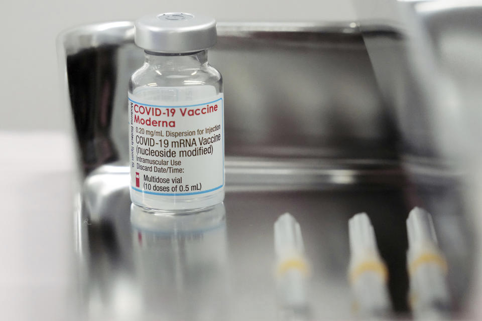 FILE - In this June 14, 2021, file photo, a vital of the Moderna COVID-19 vaccine that is being administered for flight attendants of Japan Airlines at Haneda Airport as the airline company began its workplace vaccination, in Tokyo. An array of major retailers, automakers and trading companies have started providing Moderna Inc. shots distributed by the government for free for their employees and families. After months of delays due to political and bureaucratic bungling as well as a shortage of vaccines, inoculations in Japan are taking off, and the drive is now racing down to the wire with the Olympics starting in one month. (AP Photo/Eugene Hoshiko, File)