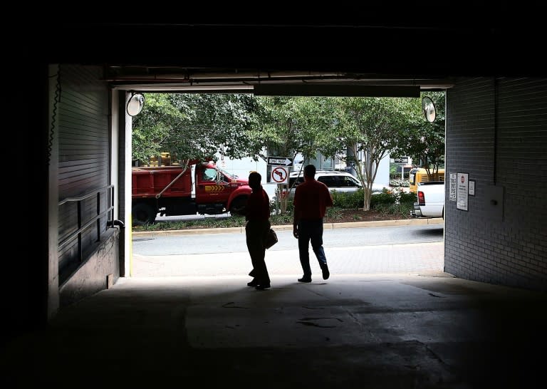 People walk out of the parking garage where Washington Post reporter Bob Woodward held late night meetings with "Deep Throat," his anonymous source on the Watergate scandal