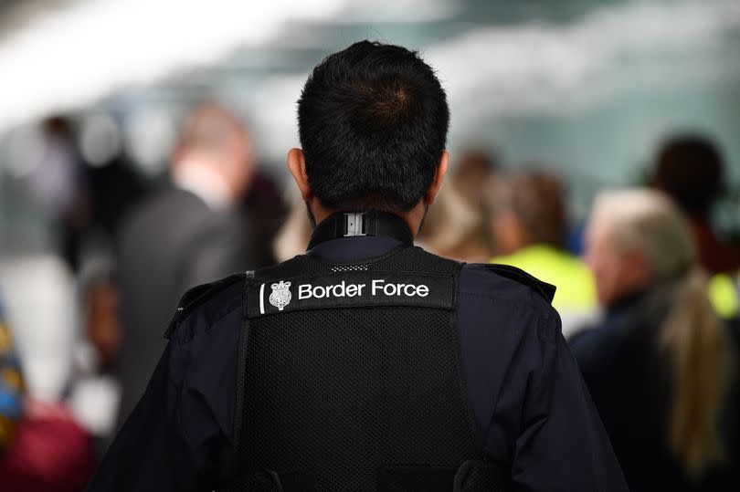 A member UK Border Force patrols at Heathrow Airport in London