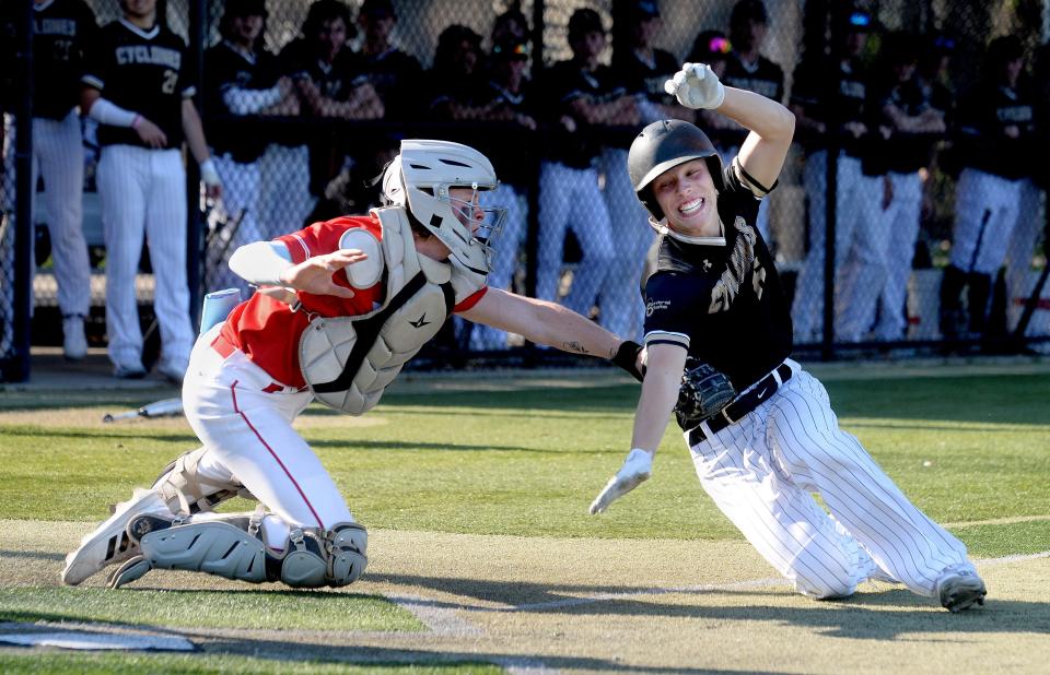 Sacred Heart-Griffin High School's Ben Raes is tagged out by Glenwood High School's catcher Griffin Graue at home plate during the game Wednesday, April 12, 2023.