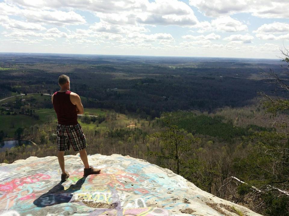 Edward Watson stands atop Currahee Mountain in northeastern Georgia on March 26, 2020. The Toccoa, Ga., resident has been quarantining alone during the COVID-19 pandemic and has been taking drives into the mountains to break up his isolation.