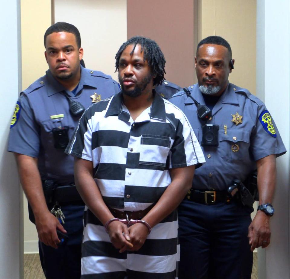 Jeremy Tremaine Williams, center, is escorted to a courtroom Wednesday afternoon for a hearing before Circuit Court Judge David Johnson at the Russell County Courthouse in Phenix City, Alabama. 03/13/2024