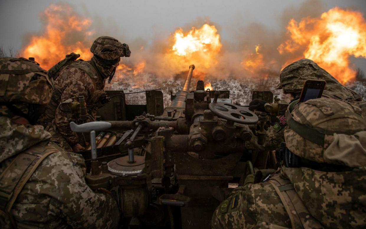 Ukrainian soldiers fire towards Russian positions on a frontline near Bakhmut - STRINGER/REUTERS
