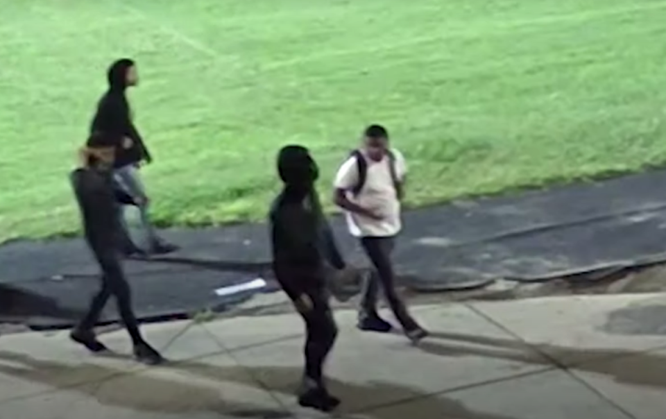Four people were seen walking across the campus in the footage (Baltimore Police)