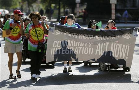 Members of ADAPT, a grassroots disability rights group that supports Obamacare, march in Washington during the U.S. government shutdown October 1, 2013. REUTERS/Gary Cameron