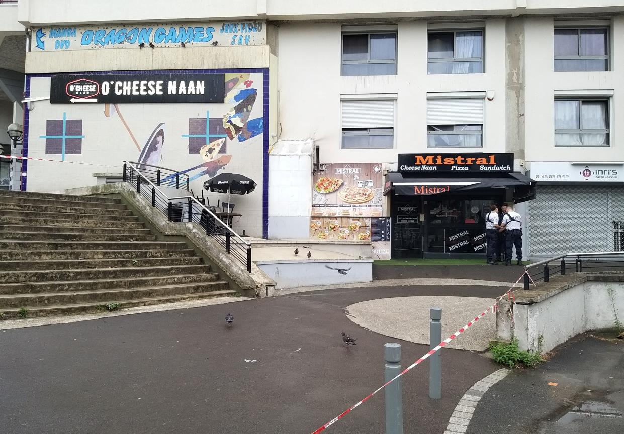 Policemen stand in front of the eatery where a waiter was shot dead by a customer allegedly angry at having to wait for a sandwich, in the eastern Paris suburb of Noisy-le-Grand on August 17, 2019.