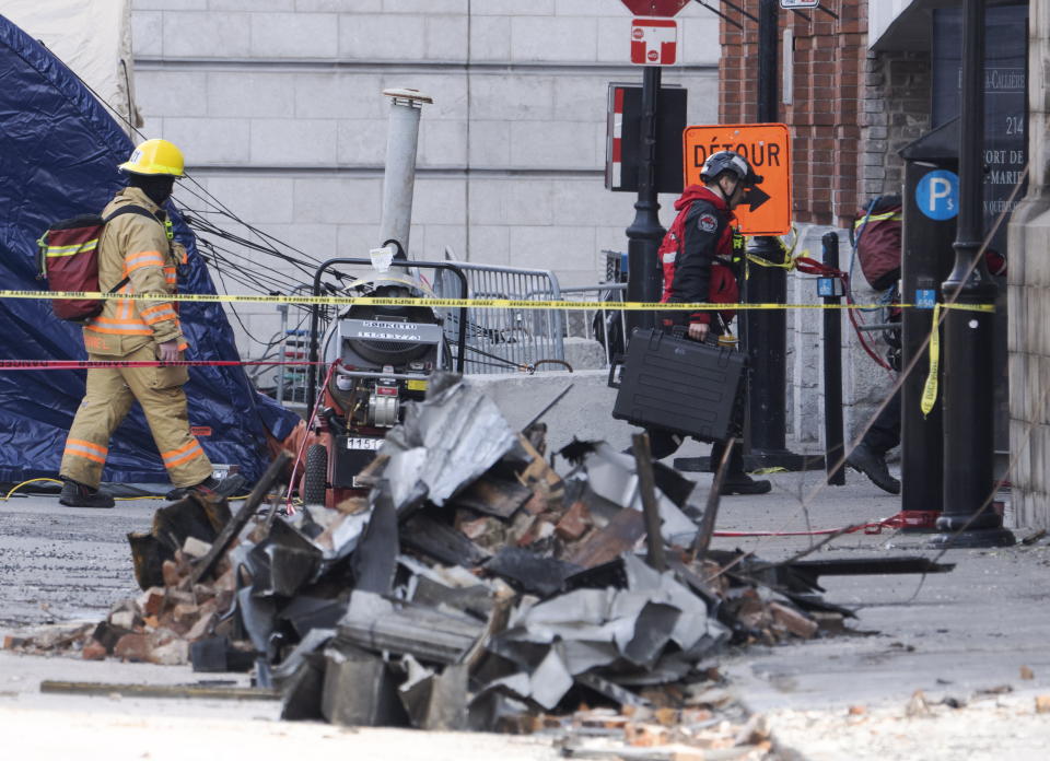 Firefighters continue the search for victims Tuesday, March 21, 2023, days after a fire swept through a building that included Airbnb units in a historic section of Montreal. Montreal’s mayor is vowing to tighten regulation of Airbnb as a search continued for six people missing after a fire swept through a building that included Airbnb units in a historic city section where they are banned. (Ryan Remiorz/The Canadian Press via AP)