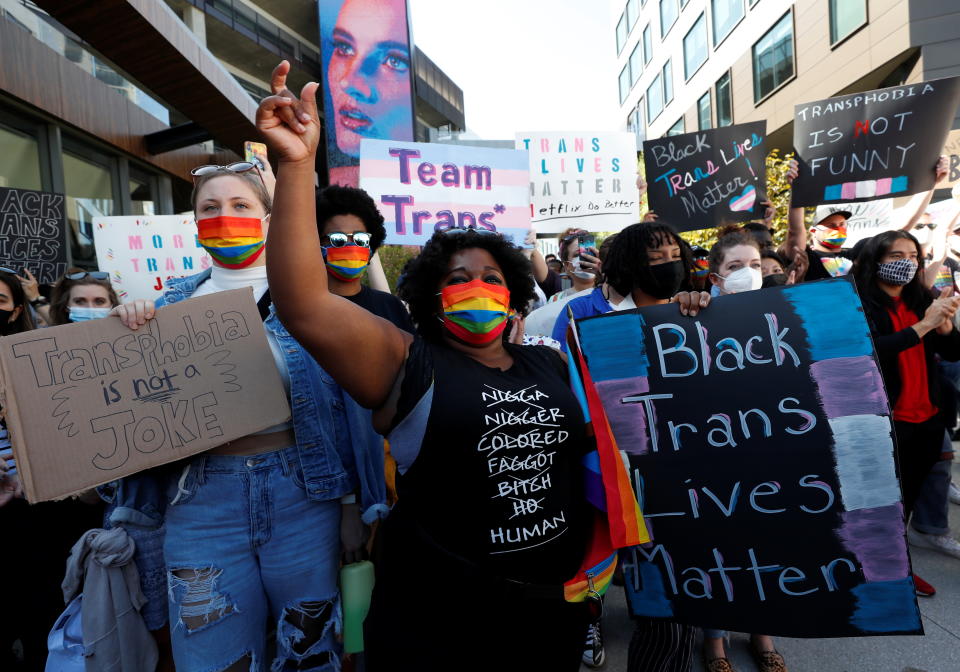 People attend a rally in support of the Netflix transgender employee walkout 