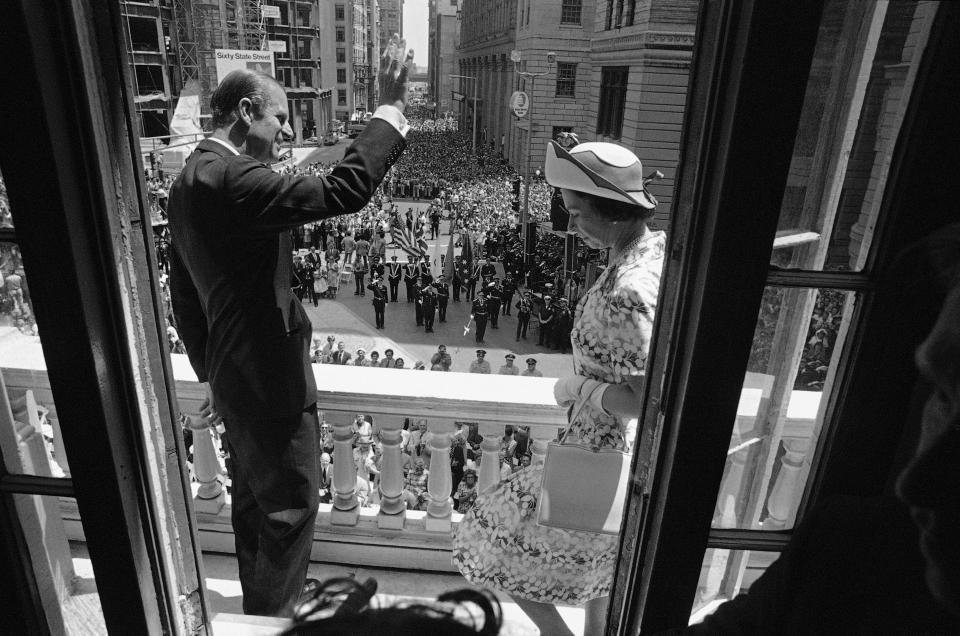 Queen Elizabeth II and Prince Philip view spectators below from balcony of the Old State House on July 11, 1976 in Boston before the Queen descended to street level to address the crowd. (AP Photo)
