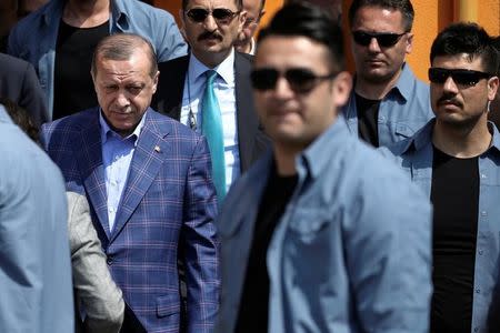 Turkish President Tayyip Erdogan leaves a polling station escorted by his security in the Uskudar district in Istanbul, Turkey April 16, 2017. REUTERS/Alkis Konstantinidis