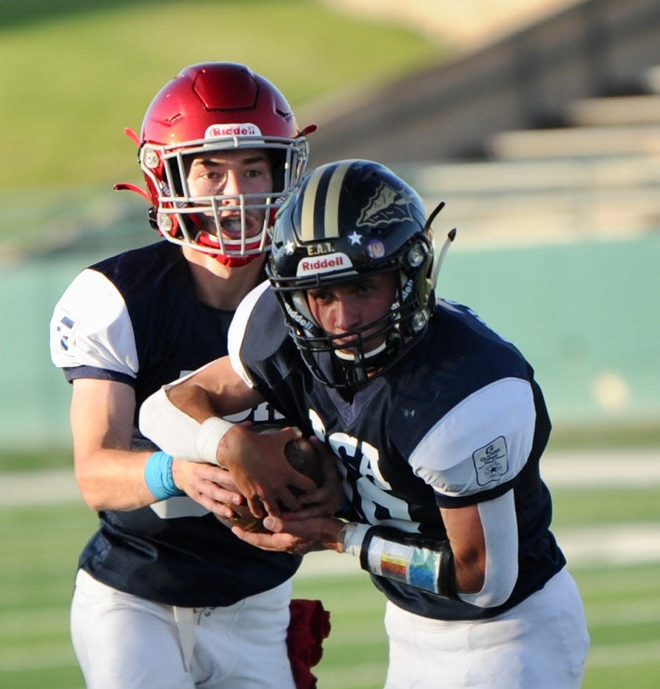 Sweetwater's Leo Holsey hands off to Comanche's Luke Wilson at the Big Country FCA All-Star Game.