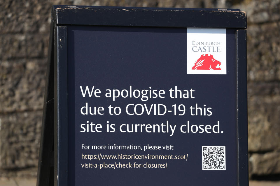A sign outside Edinburgh Castle which is closed due to coronavirus as the UK's death toll reached 144 as of 1pm on Thursday.