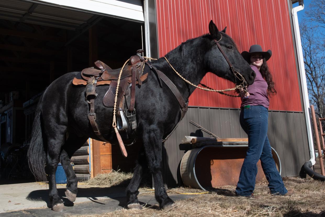 Angeline Saliceti, 16, takes her hall-of-fame black stallion, Samson, out for a ride Friday afternoon at her family's farm in northern Shawnee County.