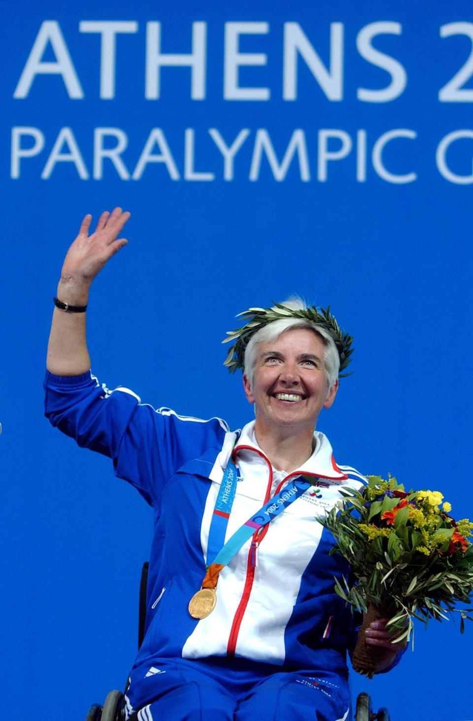 Britain's Isabel Newstead waves to the crowd with her gold medal after the 10m Air Pistol SH1 final at the Athens 2004 Paralympic Games in the Olympic Shooting Center on Sunday, Sept. 19, 2004. (AP Photo/Thanassis Stavrakis)