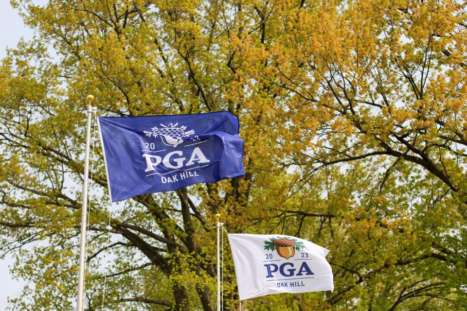 Tournament flags are seen as wind rolls through the course during a practice round of the PGA Championship golf tournament at Oak Hill Country Club.