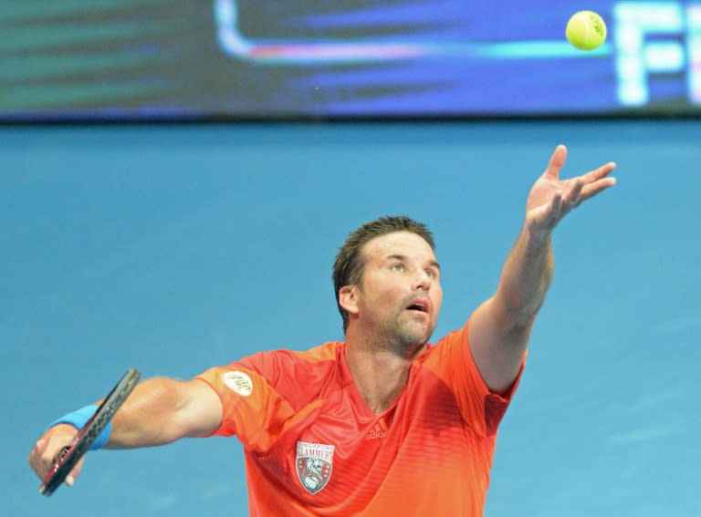 Australia's Pat Rafter serves against Croatia's Goran Ivanisevic at the International Premier Tennis League competition in Manila on November 29, 2014