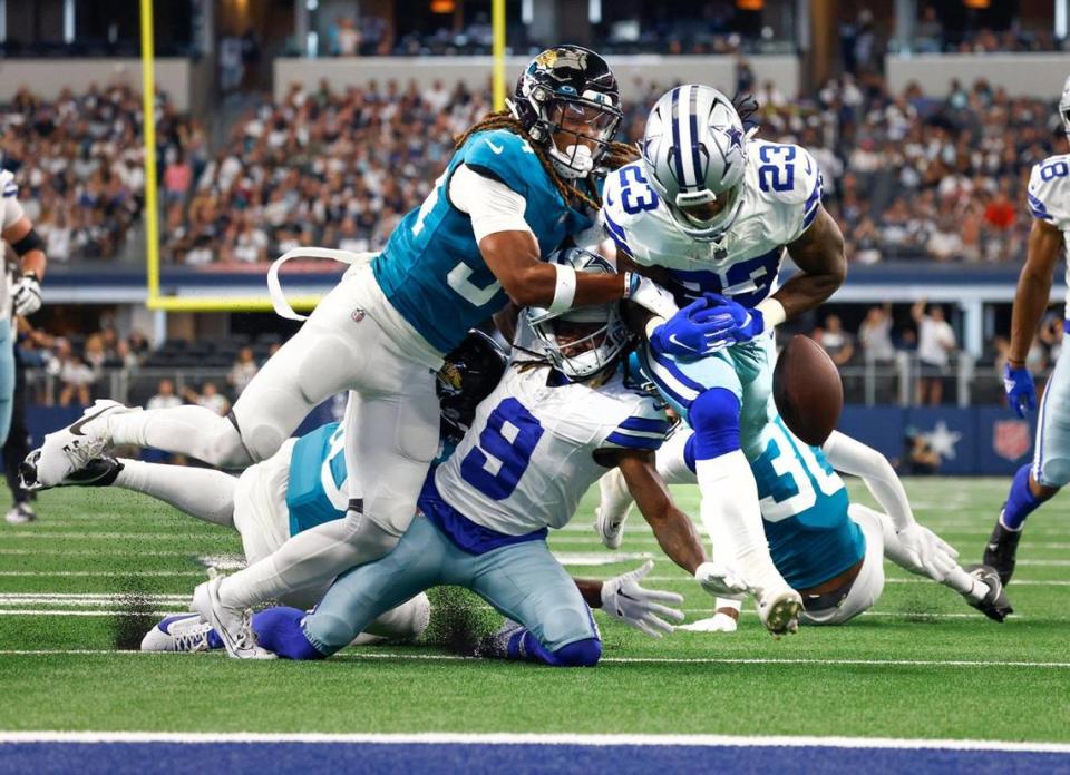 Dallas Cowboys running back Rico Dowdle fumbles the ball after receiving pressure from Jacksonville Jaguars cornerback Gregory Junior during a preseason game on Saturday, August 12, 2023, at AT&T Stadium in Arlington. Amanda McCoy/amccoy@star-telegram.com