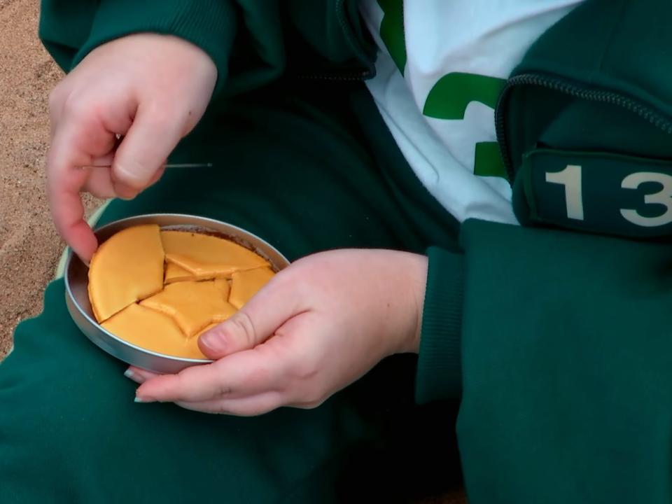 A broken cookie in a metal disk.