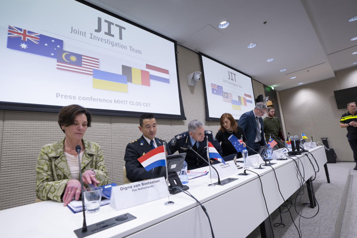 Digna van Boetzelaer, the Netherlands, Andy Kraag, the Netherlands, David McLean, Australia, Asha Hoe Soo Lian, Malaysia, Eric van der Sypt, Belgium, and Oleksandr Bannyk, Ukraine, take their seats for the Joint Investigation Team (JIT) news conference in The Hague, Netherlands, Wednesday, Feb. 8, 2023, on the results of the ongoing investigation into other parties involved in the downing of flight MH17 on 17 July 2014. The JIT investigated the crew of the Buk-TELAR, a Russian made rocket launcher, and those responsible for supplying this Russian weapon system that downed MH17. (AP Photo/Peter Dejong)