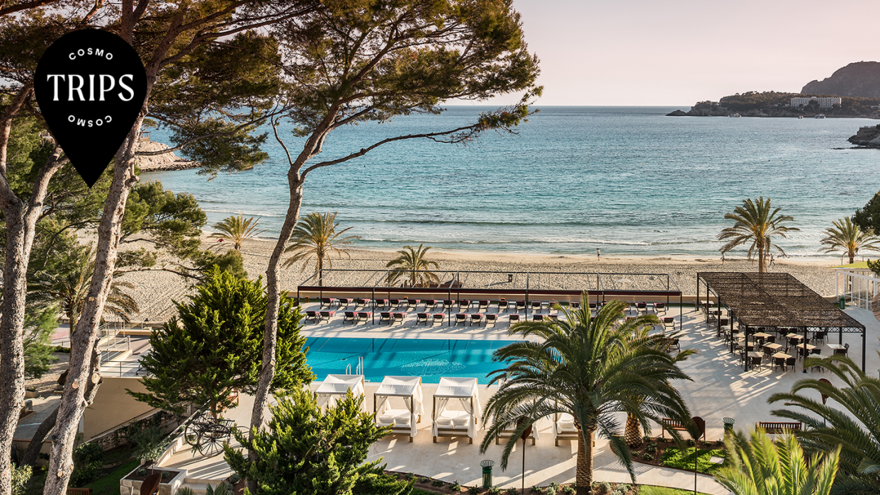 a pool with chairs and tables by it by a beach