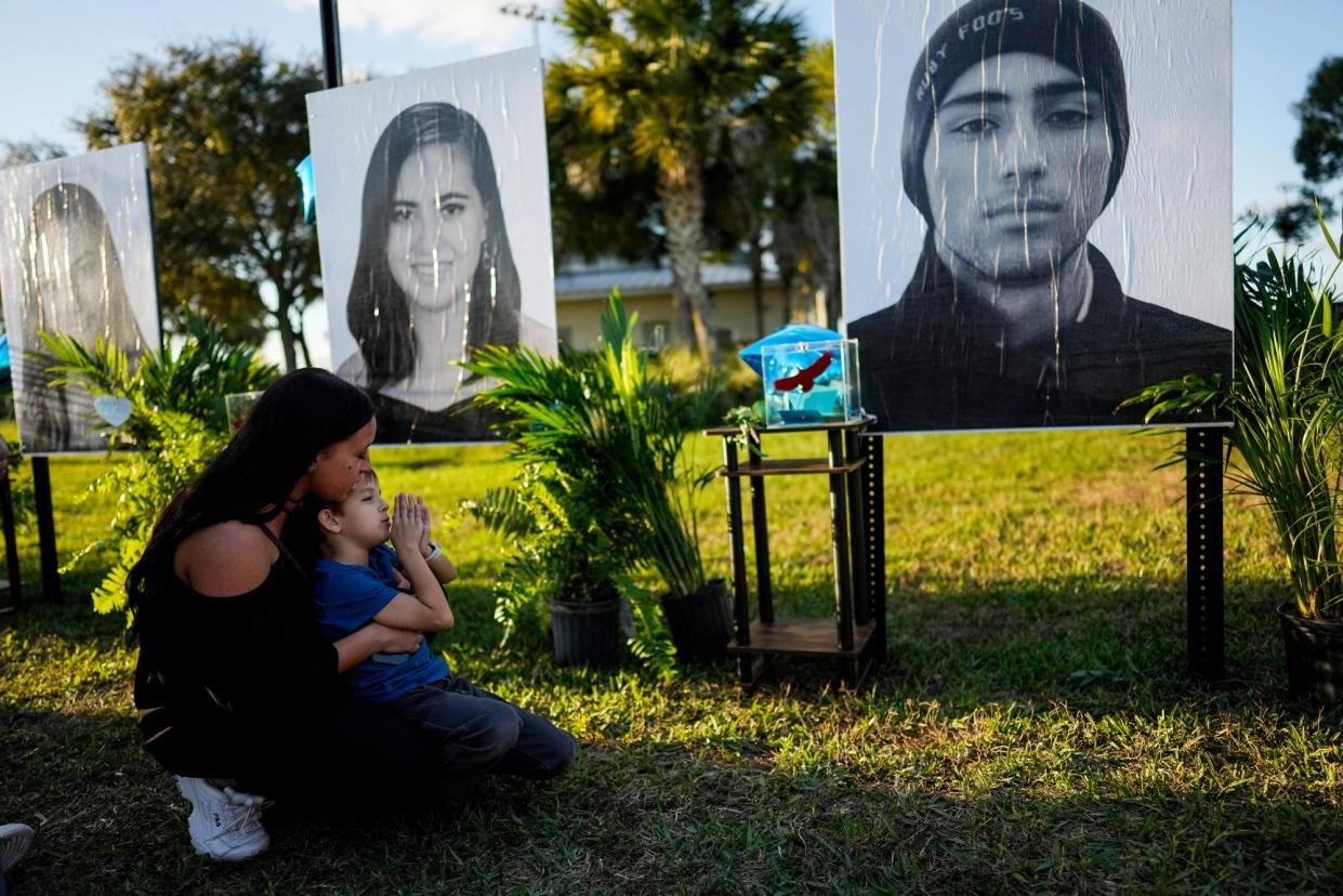 <span>Family members visit a portrait of Joaquin Oliver, right, who was killed in the mass shooting at Marjory Stoneman Douglas High School, on 14 February 2023, on the five-year anniversary of the shooting in Parkland, Florida.</span><span>Photograph: Rebecca Blackwell/AP</span>