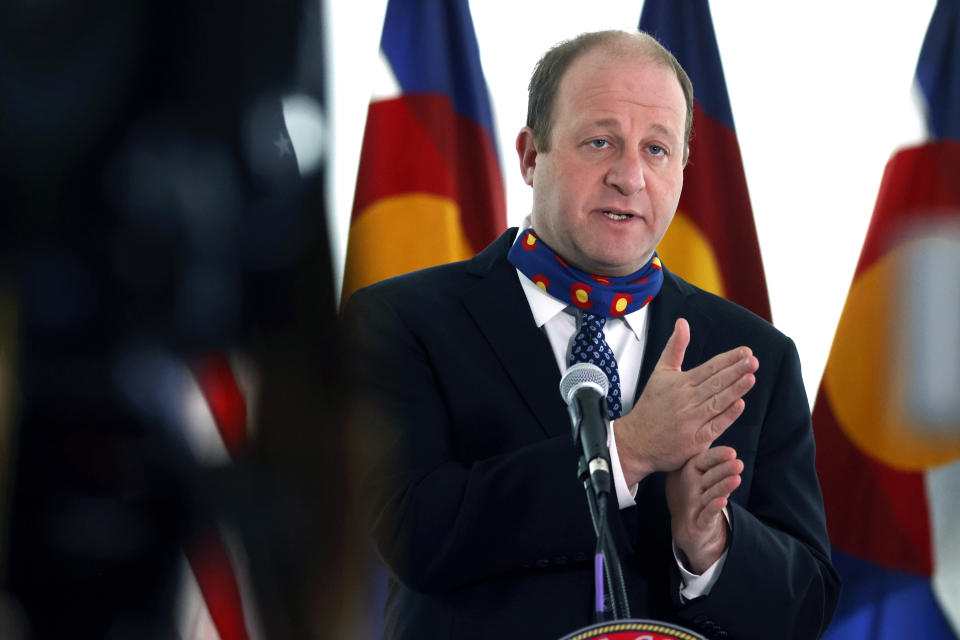 In this April 15, 2020, photo, Colorado Gov. Jared Polis speaks during a news conference to outline efforts to stem the spread of the new coronavirus in Denver. (AP Photo/David Zalubowski)