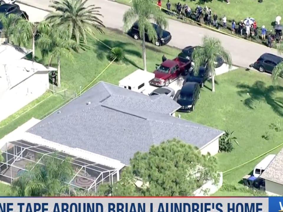 Police swarm the home of Brian Laundrie.