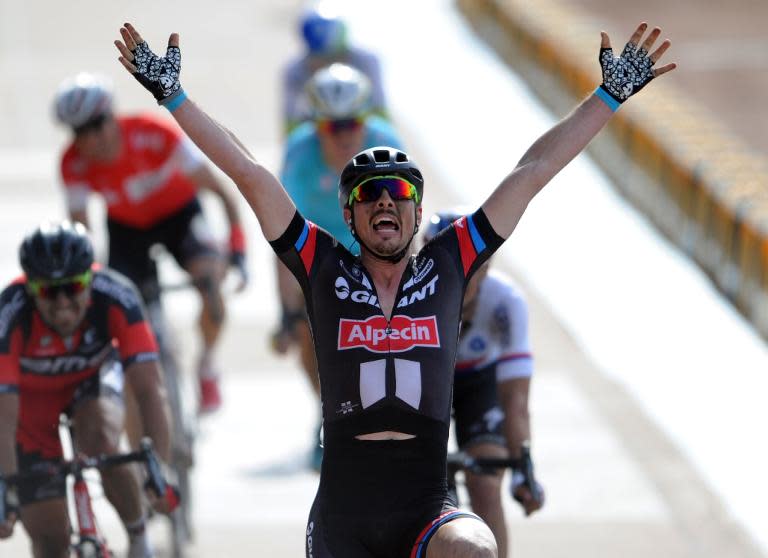 German cyclist John Degenkolb celebrates after winning the Paris-Roubaix one-day classic cycling race on April 12, 2015