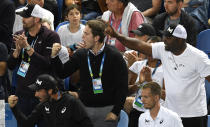 Supporters of United States' Cori "Coco" Gauff react as she won the first set tie-breaker against compatriot Venus Williams during their first round singles match at the Australian Open tennis championship in Melbourne, Australia, Monday, Jan. 20, 2020. (AP Photo/Andy Brownbill)