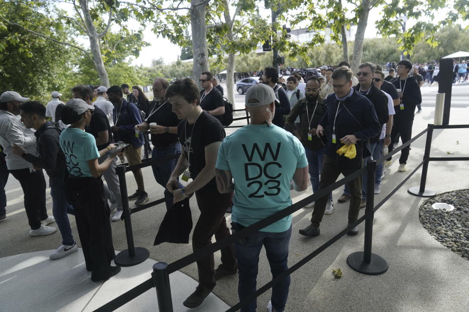 People line up to enter the Apple campus Monday, June 5, 2023, before an announcement on new products in Cupertino, Calif. (AP Photo/Jeff Chiu)
