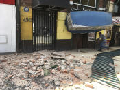 <p>A man enters a damaged building after an earthquake in Mexico City, Tuesday, Sept. 19, 2017. A powerful earthquake jolted central Mexico on Tuesday, cracking building facades and scattering rubble on streets in the capital on the anniversary of a devastating 1985 quake. (AP Photo/Eduardo Verdugo) </p>