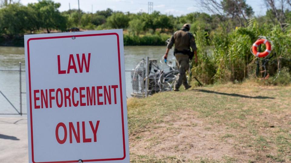 PHOTO: In this Aug. 24, 2023, file photo, law enforcement officials patrol the edge of Eagle Pass' Shelby Park, in Eagle Pass, Texas. (Suzanne Cordeiro/AFP via Getty Images, FILE)