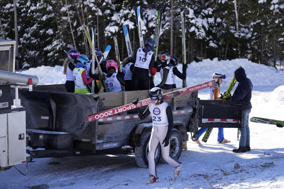 Competitors disembark from a trailer used to transport them to the top of the 39-meter jump at the Eastern Ski Jumping Meet, Sunday, Jan. 21, 2024, in Milan, N.H. Ski jumpers use extra-wide skis that are roughly one-and-a-half times their height. (AP Photo/Robert F. Bukaty)