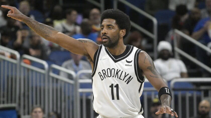 Brooklyn Nets guard Kyrie Irving (11) acknowledges a teammate.