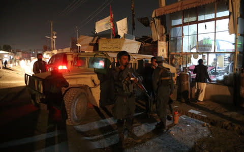 Afghan security forces stand at the site of an attack at a Shiite mosque named Imam-e-Zaman in Dasht-e-Barchi locality in Kabul, capital of Afghanistan, on Oct. 20, 2017 - Credit: Xinhua / Barcroft Images