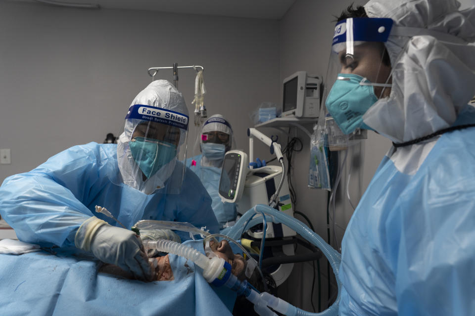 Medical staff members treat a patient suffering from the coronavirus disease (COVID-19) in the COVID-19 intensive care unit (ICU) at the United Memorial Medical Center (UMMC) on October 31, 2020 in Houston, Texas. (Go Nakamura/Getty Images)